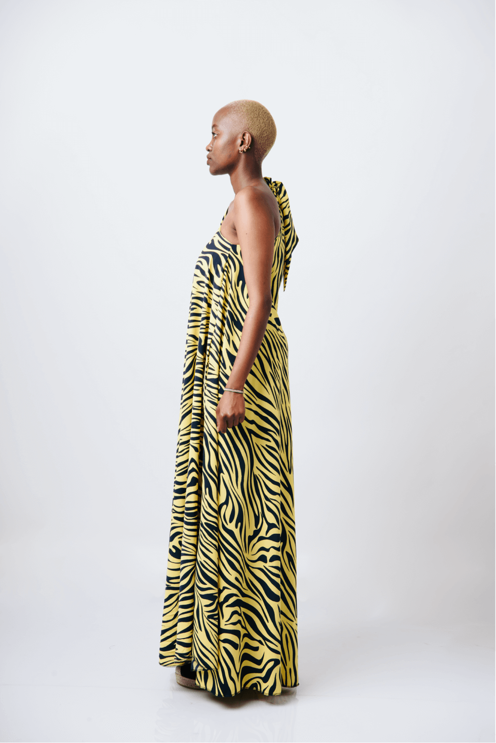 Shop Mara Tie One-Shoulder Maxi Dress by Cyami Custom Fit on Arrai. Discover stylish, affordable clothing, jewelry, handbags and unique handmade pieces from top Kenyan & African fashion brands prioritising sustainability and quality craftsmanship.