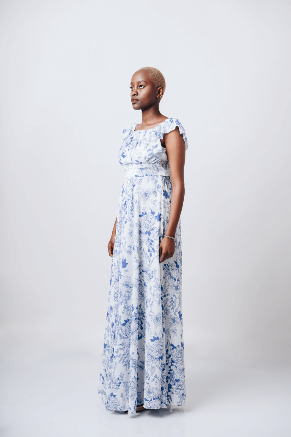 Shop Bahari White & Blue Floral Maxi Dress by Cyami Custom Fit on Arrai. Discover stylish, affordable clothing, jewelry, handbags and unique handmade pieces from top Kenyan & African fashion brands prioritising sustainability and quality craftsmanship.